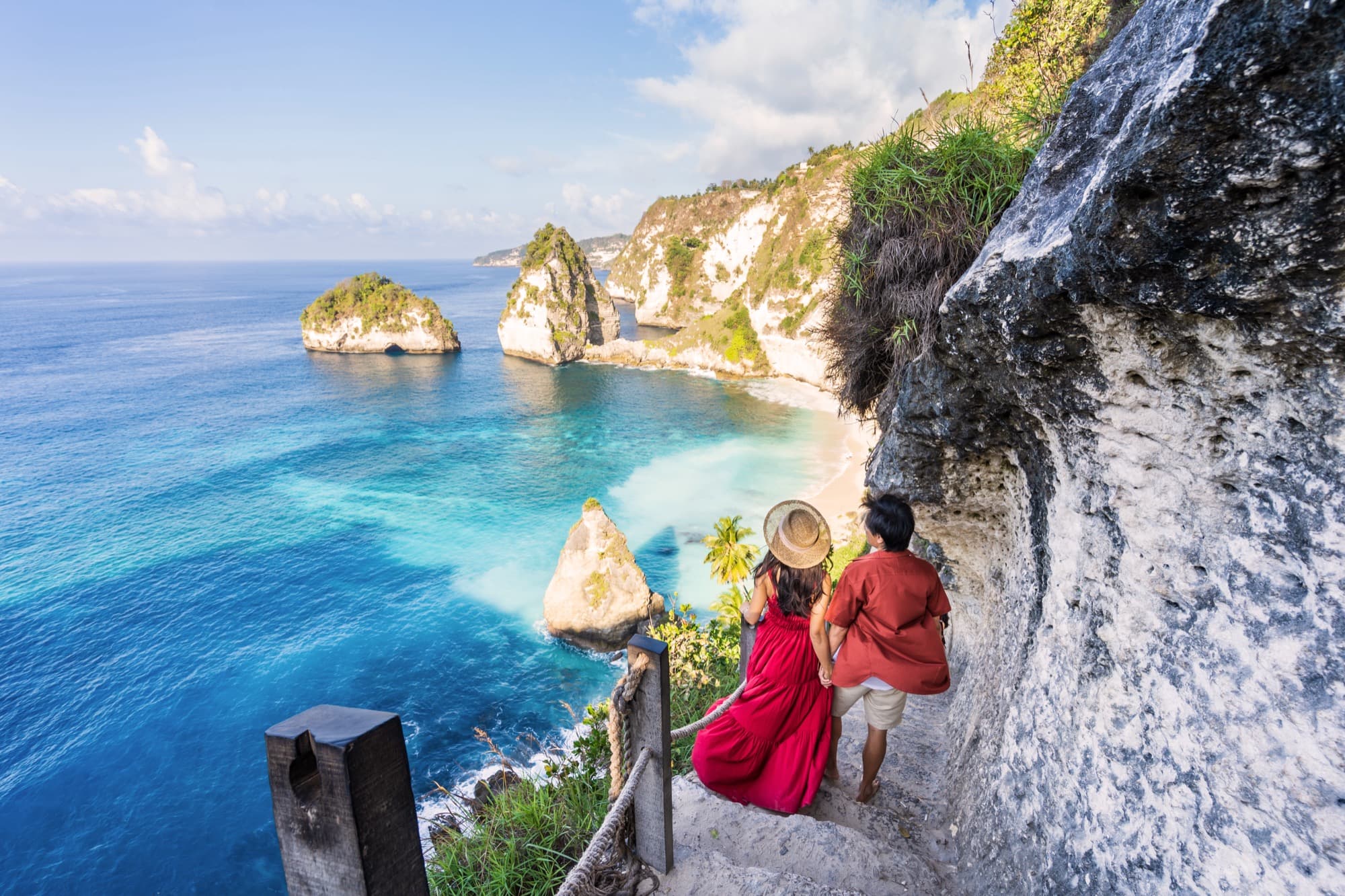 Guests walking a tropical beach stairway in Bali